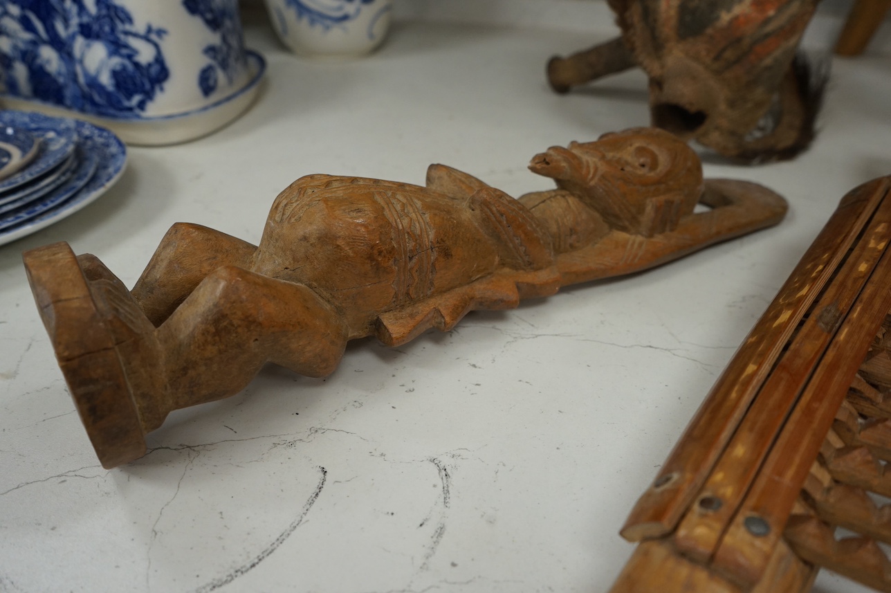 A Papua New Guinea ceremonial bone dagger, a painted straw mask, a tribal instrument and a carved stool. Condition - fair/good